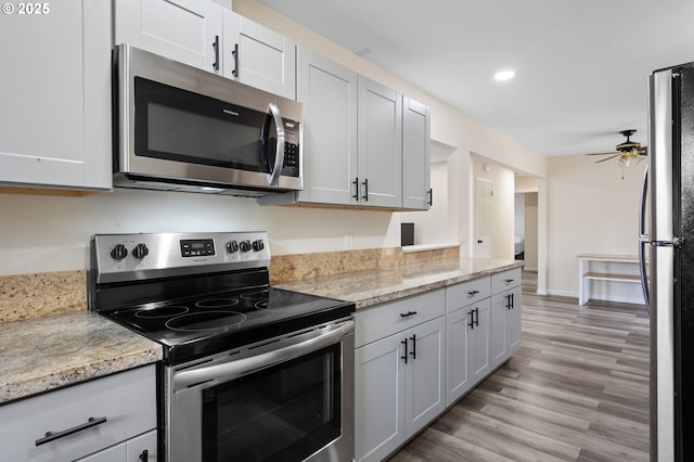 4220 SE 130th Ave, Portland, OR 97236 - kitchen featuring stainless steel appliances, a ceiling fan, light wood-type flooring, light stone counters, and recessed lighting