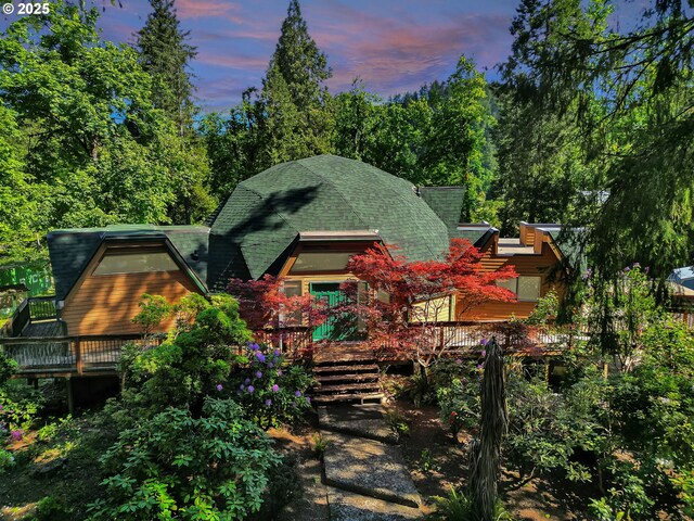 rear view of property featuring a deck