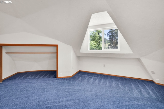 bonus room featuring carpet floors, vaulted ceiling, and baseboards