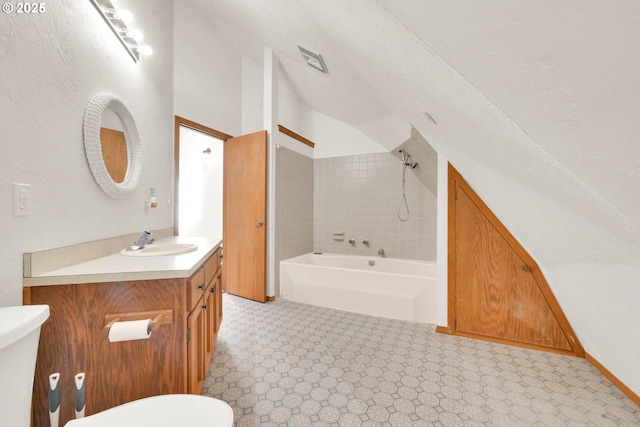 bathroom with toilet, vaulted ceiling, tub / shower combination, and vanity