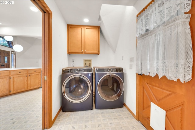 clothes washing area featuring baseboards, light flooring, washer and dryer, recessed lighting, and cabinet space