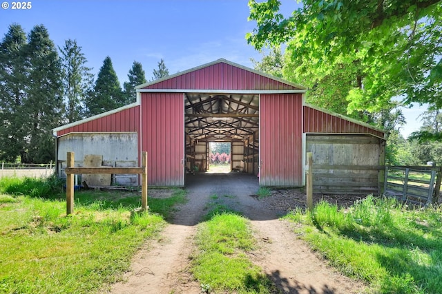 view of outdoor structure with an exterior structure, an outbuilding, and fence
