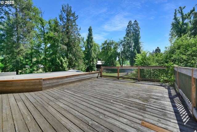 wooden deck with view of wooded area