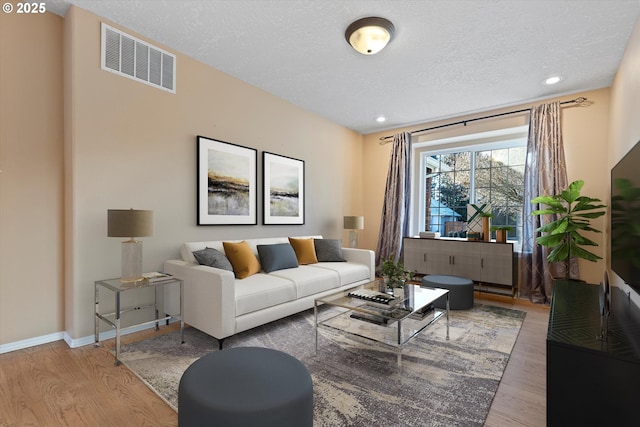 living room featuring hardwood / wood-style floors and a textured ceiling