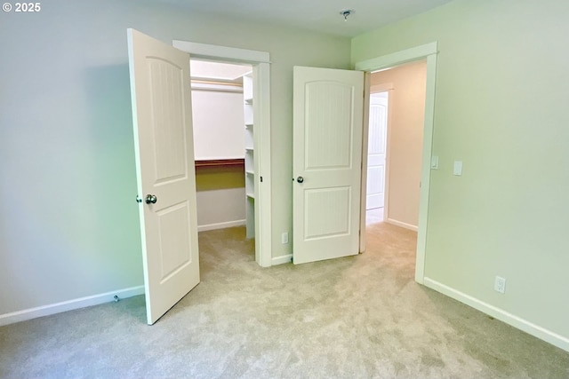 419 Salty Way, Eugene, OR 97404 - unfurnished bedroom with a walk in closet, light carpet, baseboards, and a closet