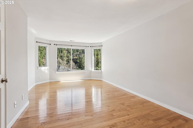 unfurnished room featuring light wood-style floors and baseboards