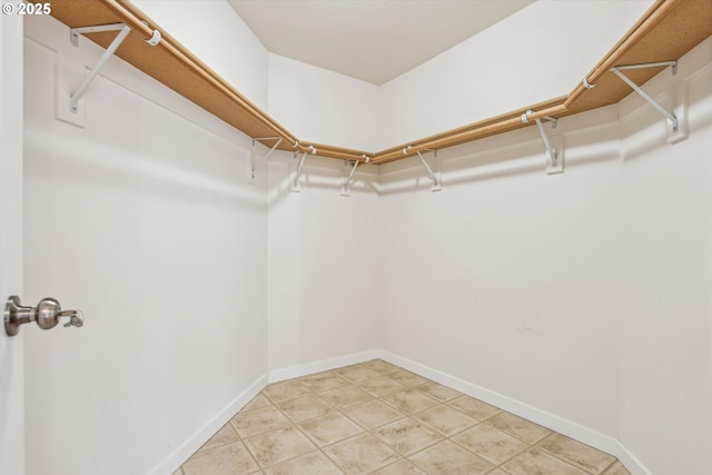 spacious closet featuring light tile patterned floors