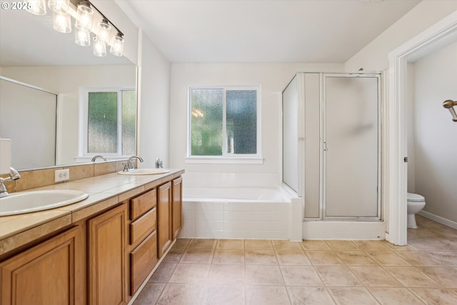full bathroom featuring double vanity, a shower stall, a sink, and a bath