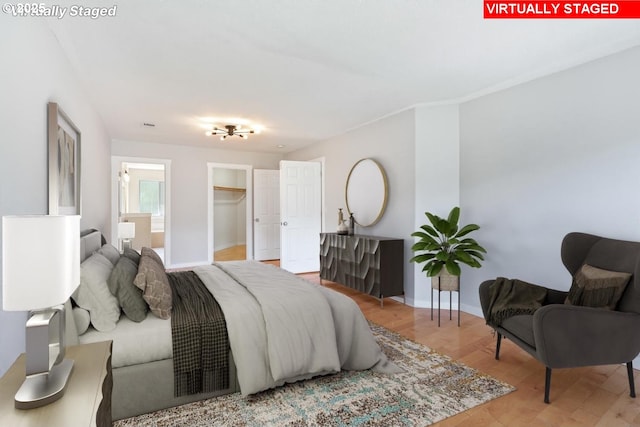 bedroom with baseboards and wood finished floors