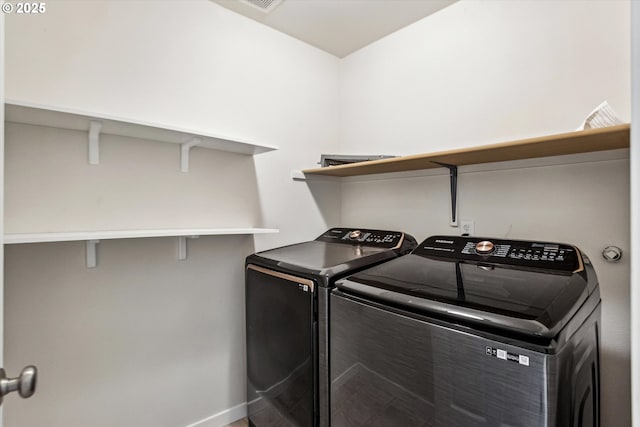 laundry area featuring laundry area, washing machine and dryer, and baseboards