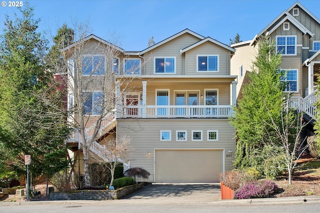 view of front facade with stairway, board and batten siding, concrete driveway, and a garage