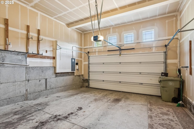 garage with a garage door opener and electric panel