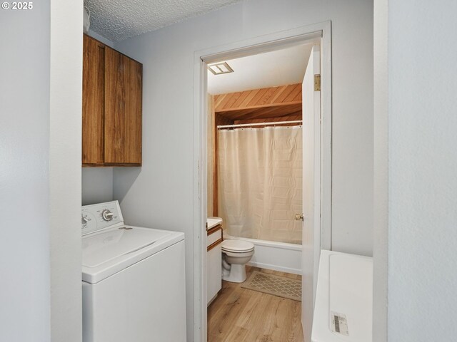 6103 SE 83rd Ave, Portland, OR 97266 - laundry room featuring washer / dryer, cabinet space, and light wood-style floors