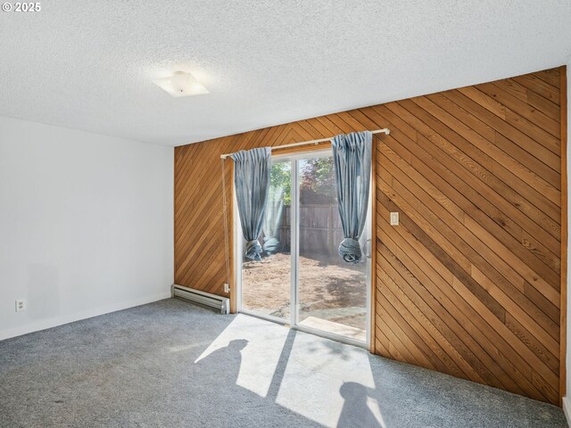 6103 SE 83rd Ave, Portland, OR 97266 - unfurnished room with wood walls, carpet flooring, a baseboard heating unit, and a textured ceiling