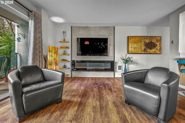 2393 SW Park Pl Unit 113, Portland, OR 97205 - living area with wood finished floors and a large fireplace
