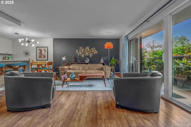 2393 SW Park Pl Unit 113, Portland, OR 97205 - living area with wood finished floors and a chandelier