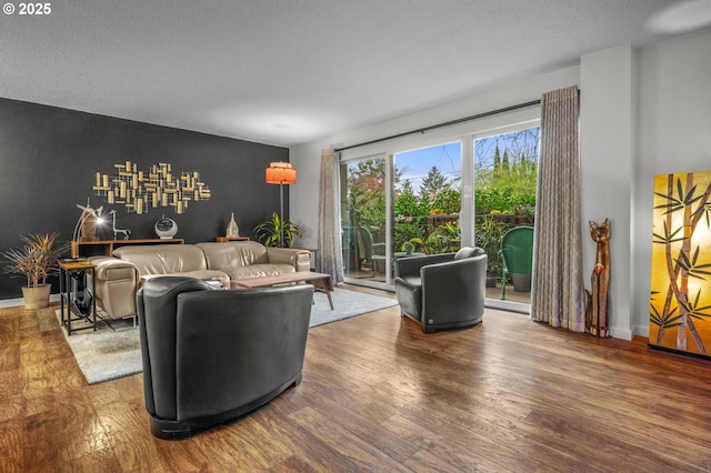 2393 SW Park Pl Unit 113, Portland, OR 97205 - living area featuring wood finished floors, a textured ceiling, and baseboards