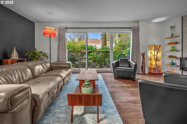 2393 SW Park Pl Unit 113, Portland, OR 97205 - living area featuring wood finished floors and a textured ceiling