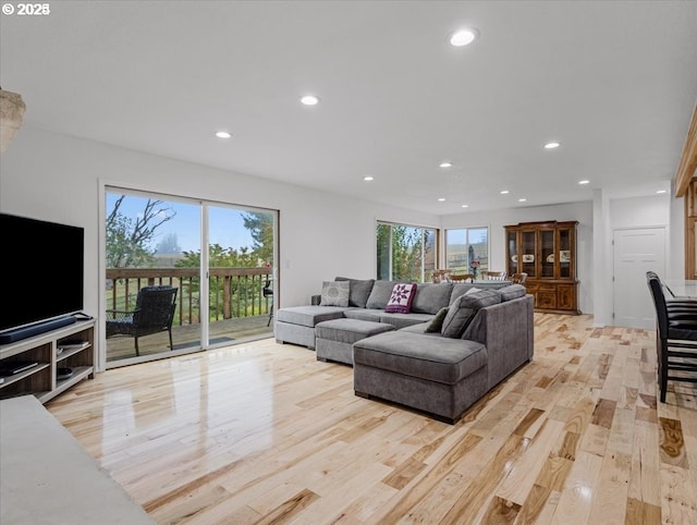 living room with recessed lighting and light wood-style flooring