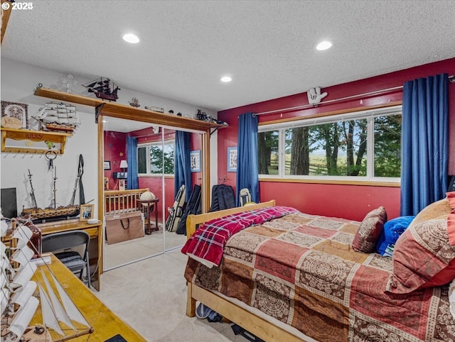 carpeted bedroom with a textured ceiling and recessed lighting