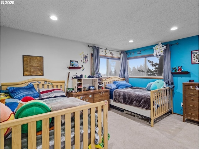 carpeted bedroom with recessed lighting and a textured ceiling