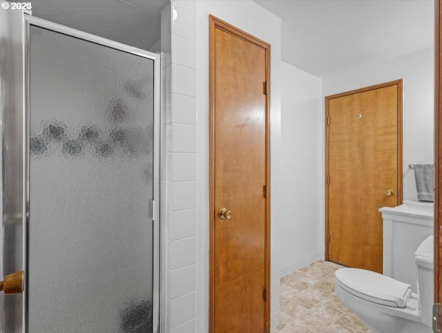 bathroom with a shower stall and toilet