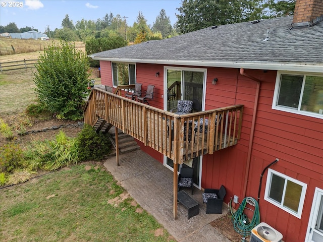 deck with a yard, a patio area, and fence