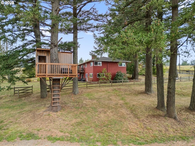 view of yard featuring fence and a wooden deck
