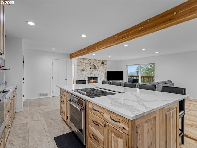 kitchen featuring stainless steel oven, visible vents, recessed lighting, open floor plan, and black electric stovetop