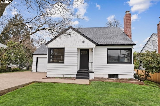 view of front of house with a shingled roof, fence, entry steps, a front yard, and driveway