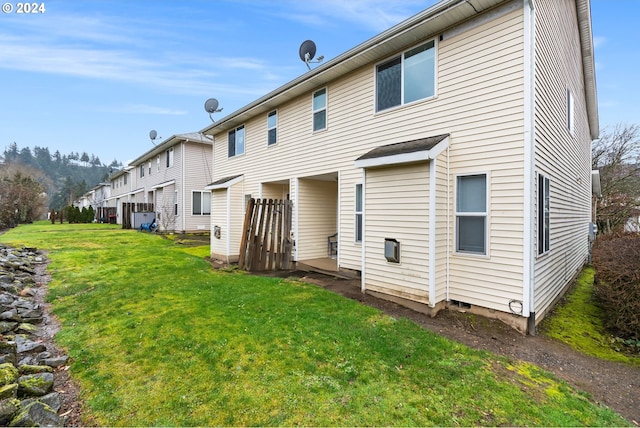 back of house with a yard