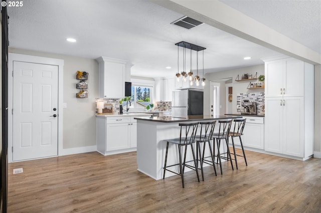 6696 Doral Dr SE, Salem, OR 97306 - kitchen featuring freestanding refrigerator, open shelves, tasteful backsplash, white cabinetry, and recessed lighting