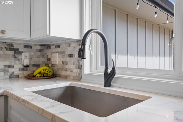 6696 Doral Dr SE, Salem, OR 97306 - kitchen view of a sink, light stone counters, tasteful backsplash, and white cabinetry