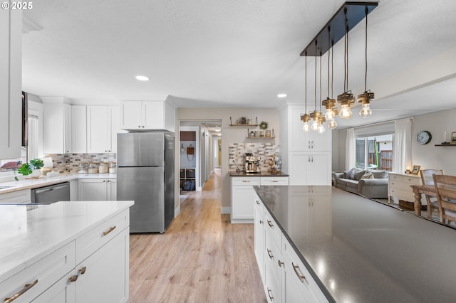 6696 Doral Dr SE, Salem, OR 97306 - kitchen featuring appliances with stainless steel finishes, tasteful backsplash, recessed lighting, light wood finished floors, and white cabinets