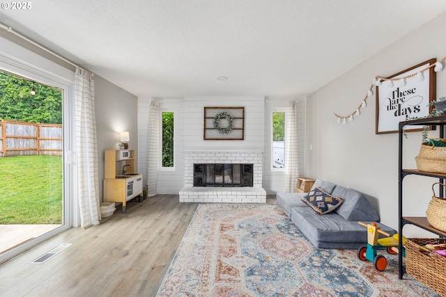 6696 Doral Dr SE, Salem, OR 97306 - living area featuring healthy amount of natural light, wood finished floors, and a fireplace