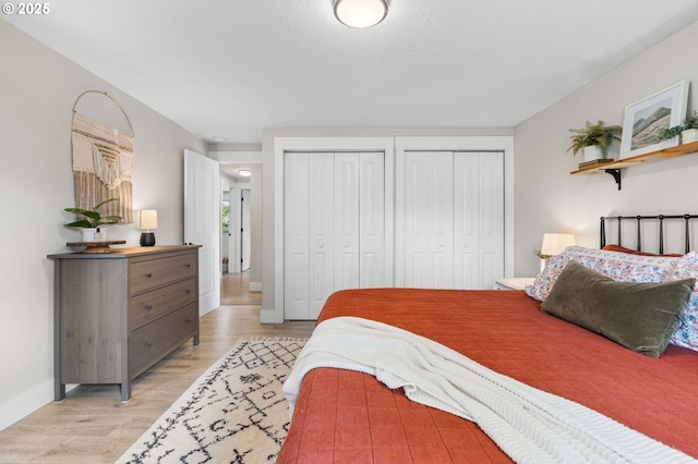 6696 Doral Dr SE, Salem, OR 97306 - bedroom featuring multiple closets, light wood-style flooring, and baseboards