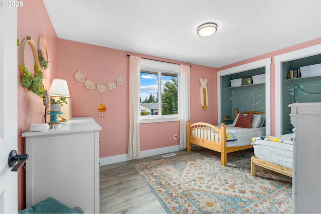 6696 Doral Dr SE, Salem, OR 97306 - bedroom featuring light wood-style floors, baseboards, and a textured ceiling