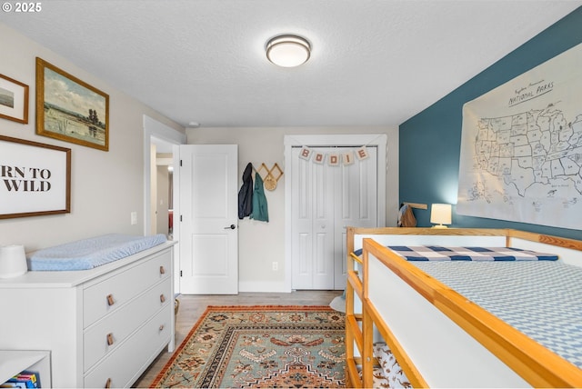 6696 Doral Dr SE, Salem, OR 97306 - bedroom with a textured ceiling, wood finished floors, and a closet