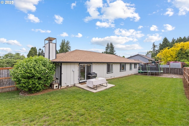 6696 Doral Dr SE, Salem, OR 97306 - back of house with a trampoline, a chimney, board and batten siding, a patio area, and roof with shingles