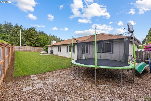6696 Doral Dr SE, Salem, OR 97306 - back of property featuring a trampoline, board and batten siding, and a shingled roof
