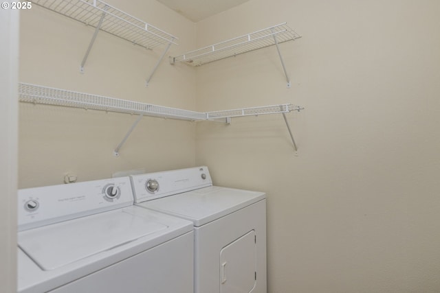 clothes washing area featuring laundry area and washing machine and dryer