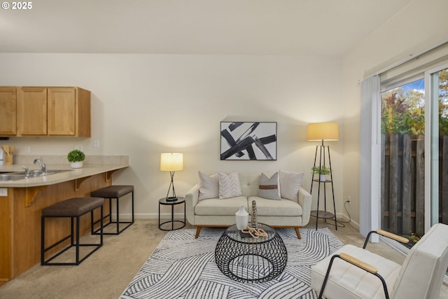 living room with baseboards and light carpet