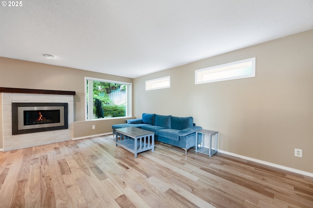1412 SW Chastain Ave, Gresham, OR 97080 - living room featuring wood finished floors and a warm lit fireplace