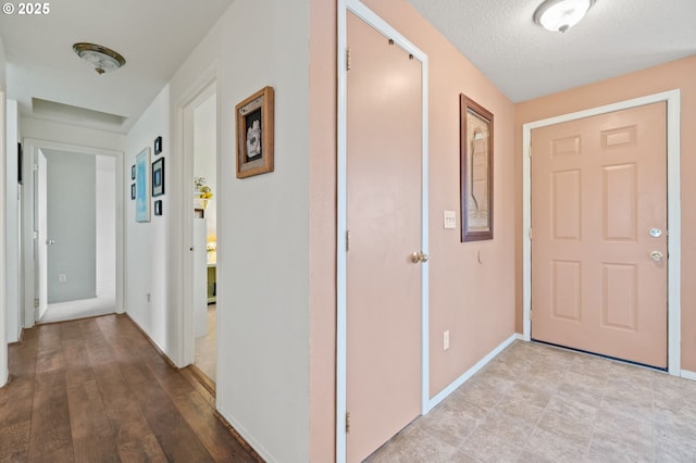 hallway featuring a textured ceiling