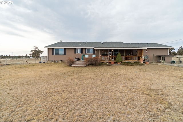 rear view of property featuring a yard