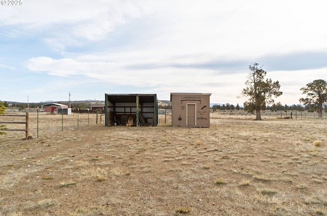 view of yard with a rural view and an outbuilding