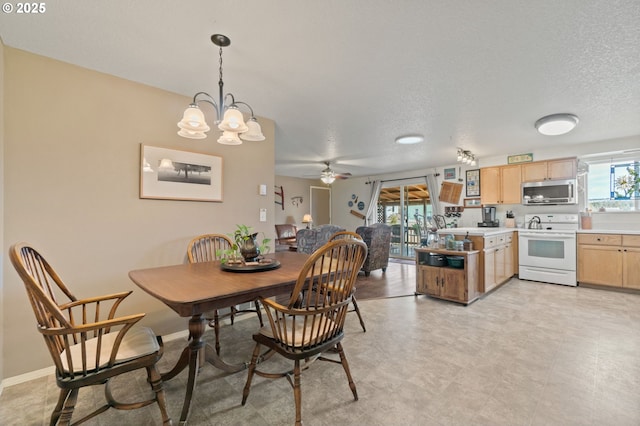 dining area featuring an inviting chandelier and a textured ceiling