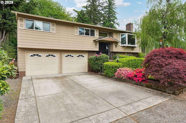 2202 NE 203rd Ave, Fairview, OR 97024 - bi-level home with a chimney, a garage, and concrete driveway