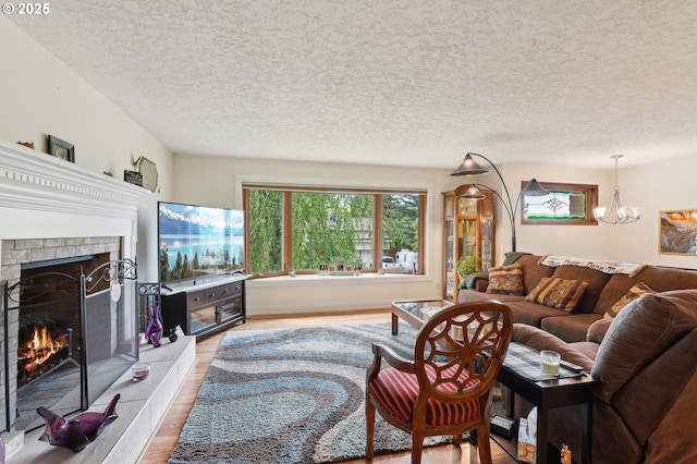 2202 NE 203rd Ave, Fairview, OR 97024 - living area with light wood-type flooring, a fireplace, a chandelier, and a textured ceiling