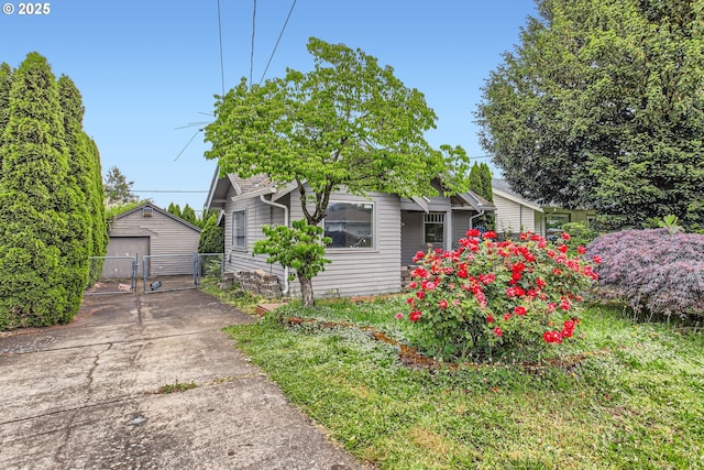 6861 N Sky St, Portland, OR 97203 - view of front of home with a gate, a garage, concrete driveway, and an outbuilding